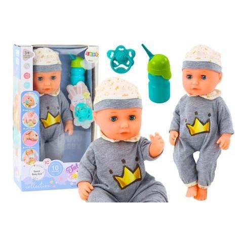 Lean Toys Eine Babypuppe im grauen Schlafanzug und eine Flasche pinkeln (49676339)