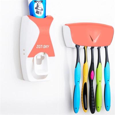 Snug & Styled Automatic Toothpaste Dispenser And Wall Mounted Toothbrush Holder Set orange
