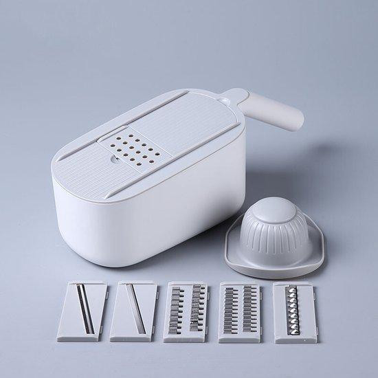 Witte plastic mandoline met meerdere messen voor het snijden van groenten en fruit