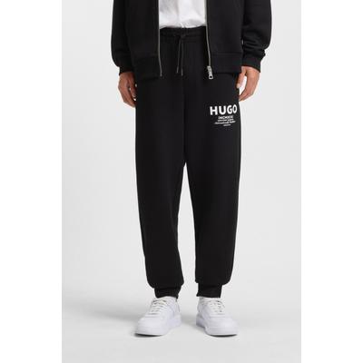 Jogginghose HUGO "Nevez", Herren, Gr. L, N-Gr, schwarz (schwarz005), Sweatware, Obermaterial: 100% Baumwolle, unifarben, oversize lang, Hosen Jogginghose, mit Beinbündchen und Oversize-Passform