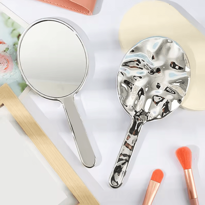 Inspire Curations Liquid Ellipsoid Handheld Desktop Makeup Mirror silver