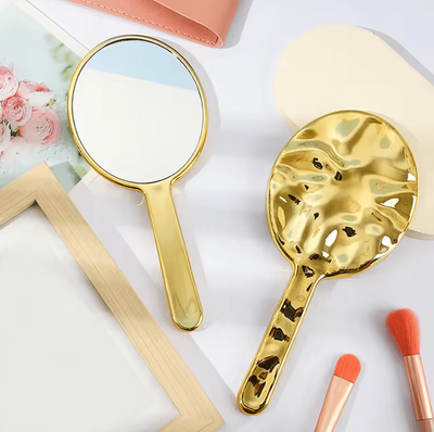 Inspire Curations Liquid Ellipsoid Handheld Desktop Makeup Mirror gold