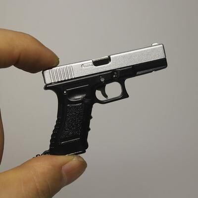 The Handy Homestead Mini Pistol Keychain Toy With Removable Magazine & Collectible Charm black White