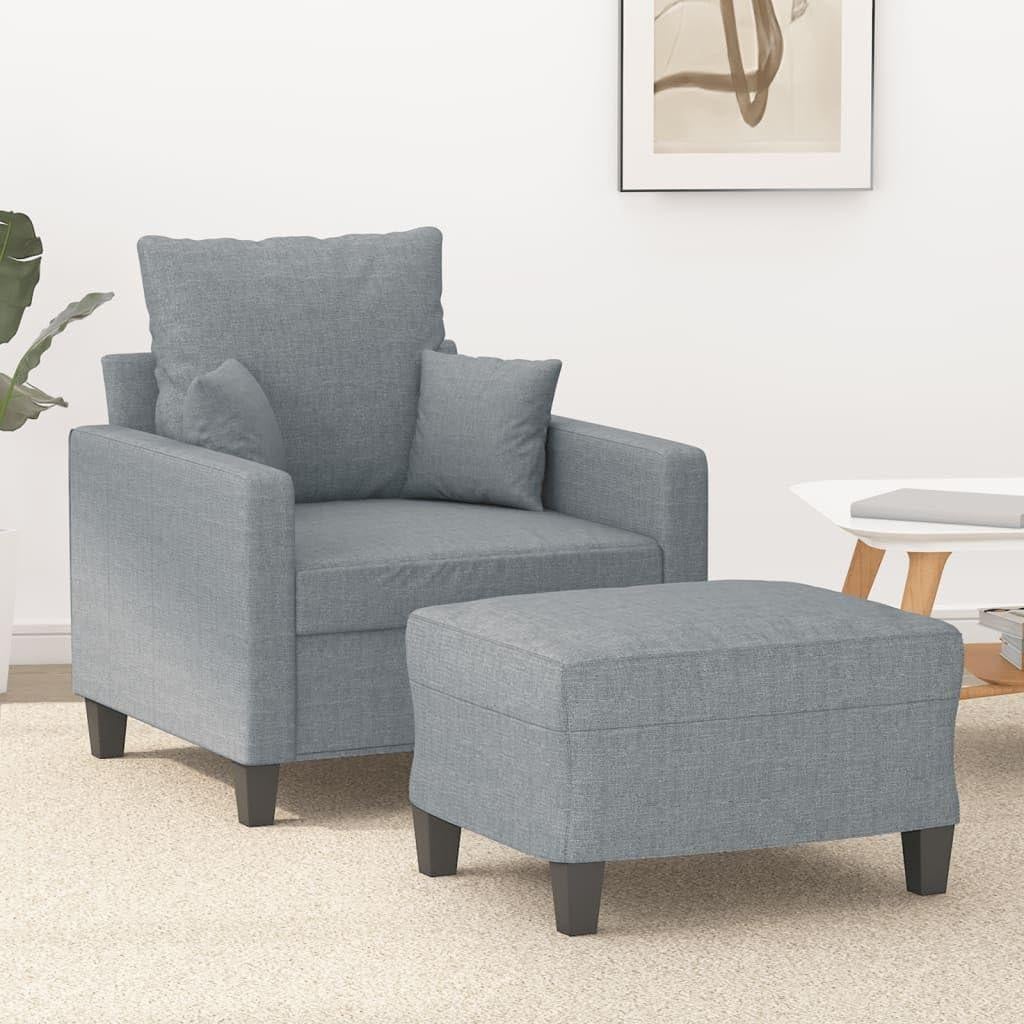Moderne grijze fauteuil met bijpassende stoffen poef voor de woonkamer