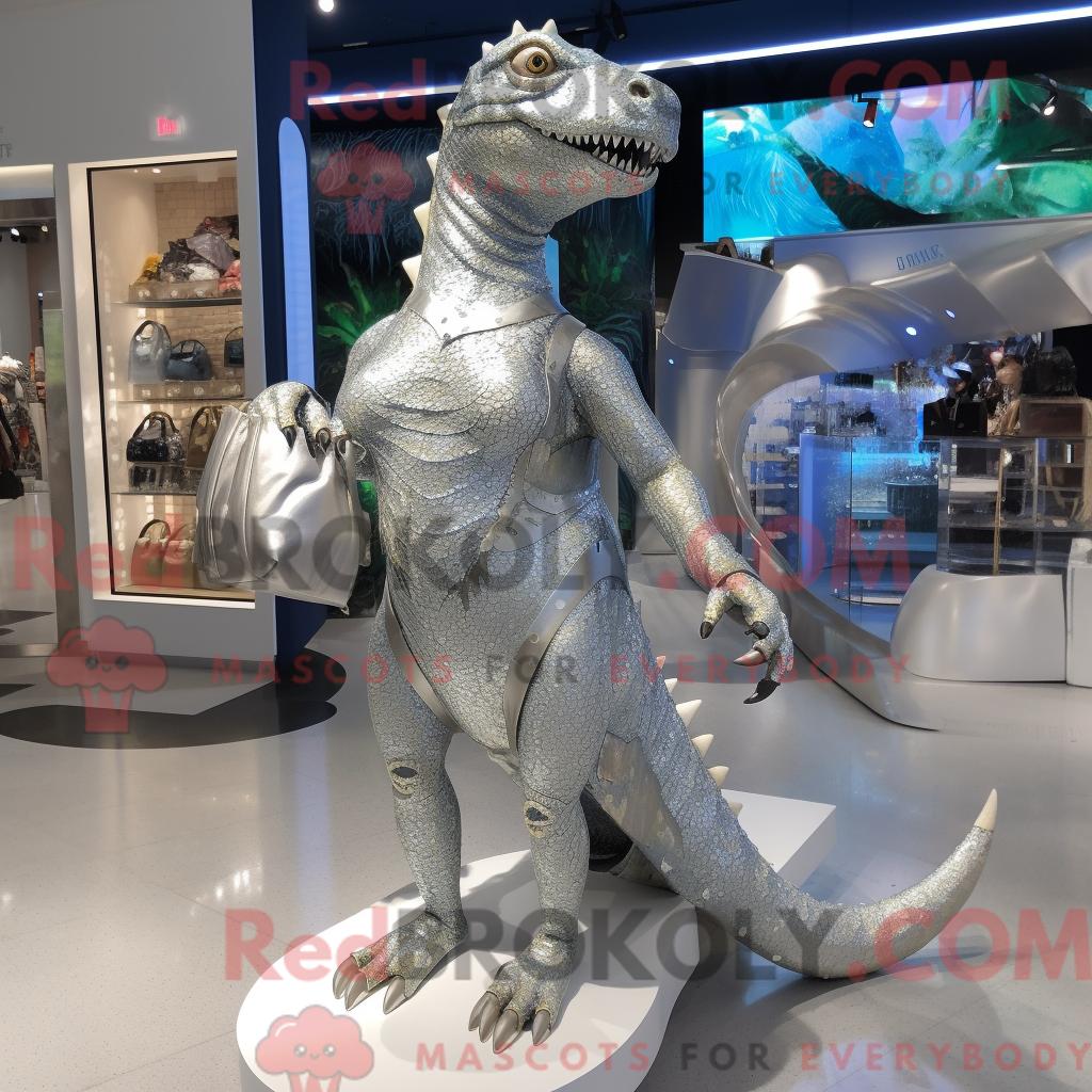 Maskottchenfigur REDBROKOLY eines silbernen Iguanodons mit Bikini und Handtasche