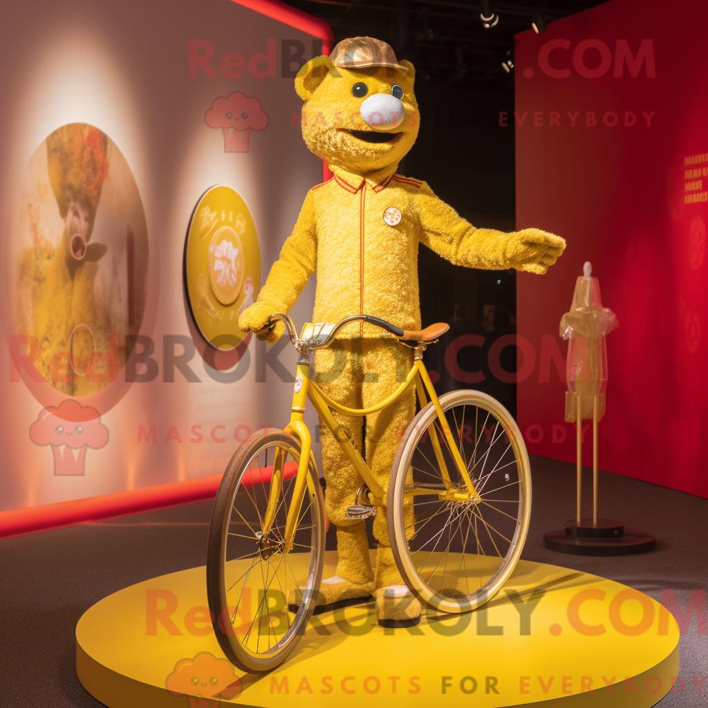 Maskottchen REDBROKOLY eines goldenen Einradfahrers mit Henley-Shirt und Broschen