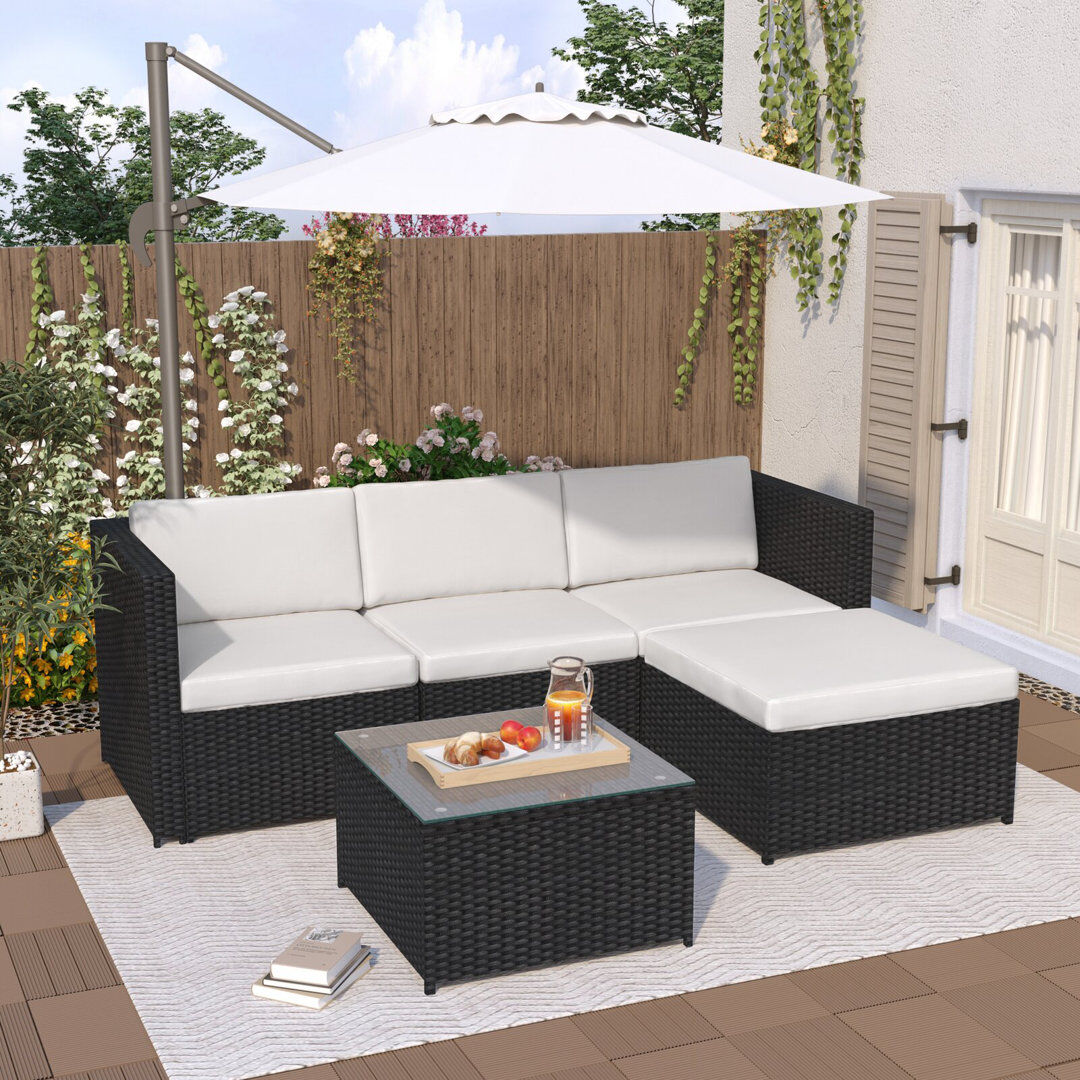 Ebern Designs Rattan Garden Sofa Set With Glass Top Coffee Table Black Rupert/Cream 4