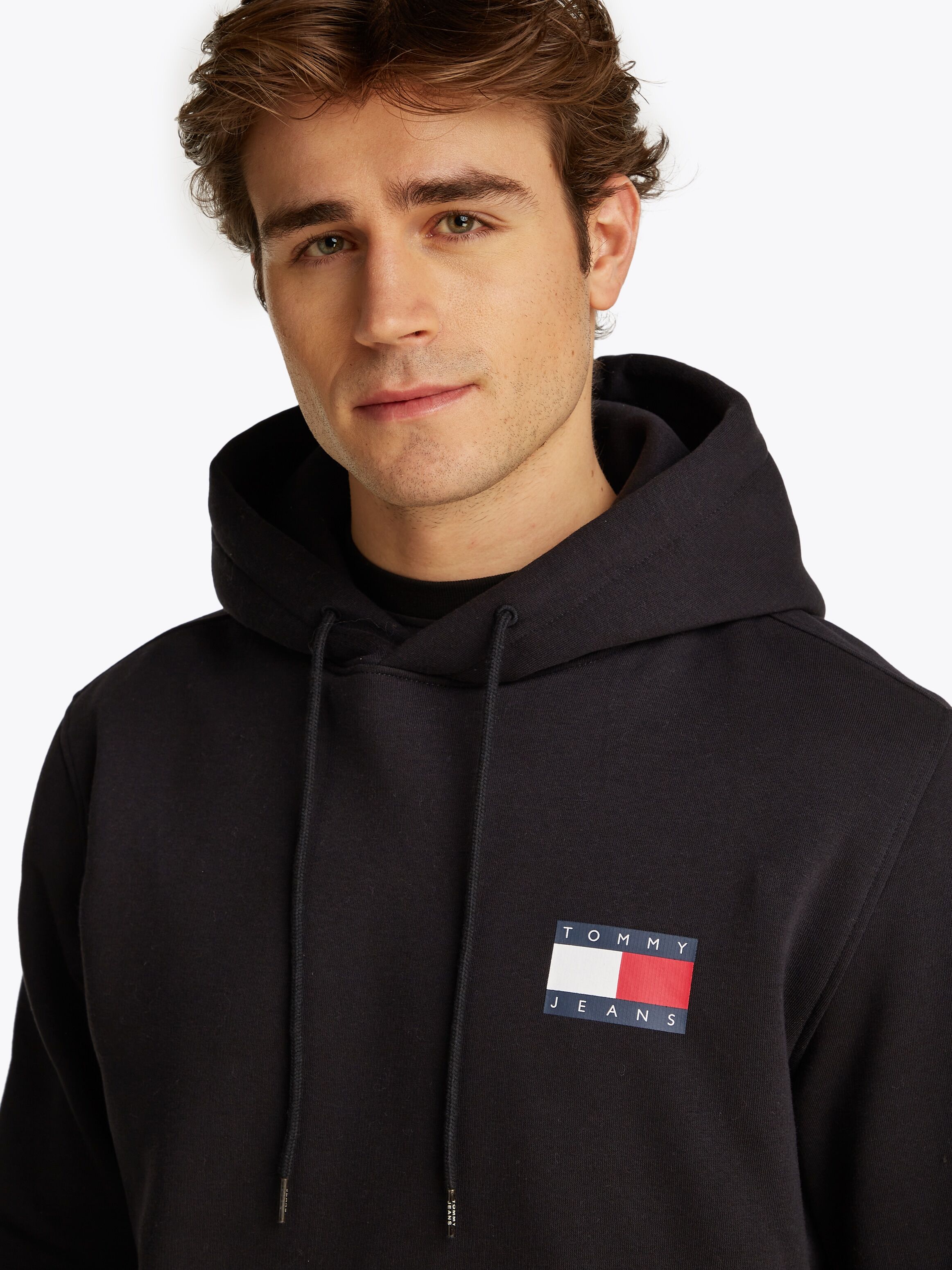 Sweatshirt TOMMY JEANS "TJM REG ESSENTIAL FLAG HOOD EXT", Herren, Gr. S, schwarz, Sweatware, Obermaterial: 100% Baumwolle, unifarben, regular fit, breiter Bund, Sweatshirts Sweatshirt, mit bedruckten Markenlogo auf Brusthöhe schwarz S