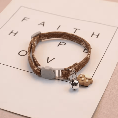 Inspire Curations PawCharm Breakaway Cat Collar With Bell & Paw Print Design brown