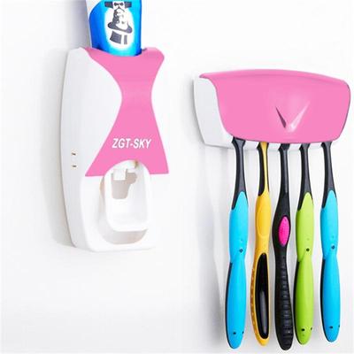 Snug & Styled Automatic Toothpaste Dispenser And Wall Mounted Toothbrush Holder Set pink
