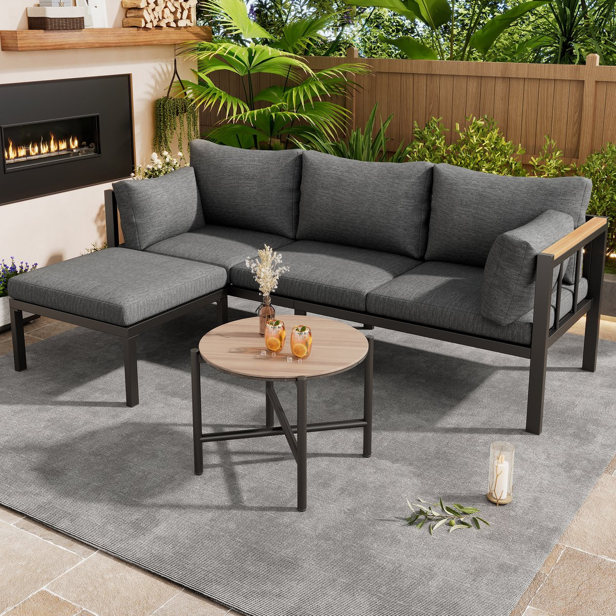 Moderne grijze tuinmeubelset met L-vormige hoekbank, hocker en glazen tafel van gepoedercoat staal